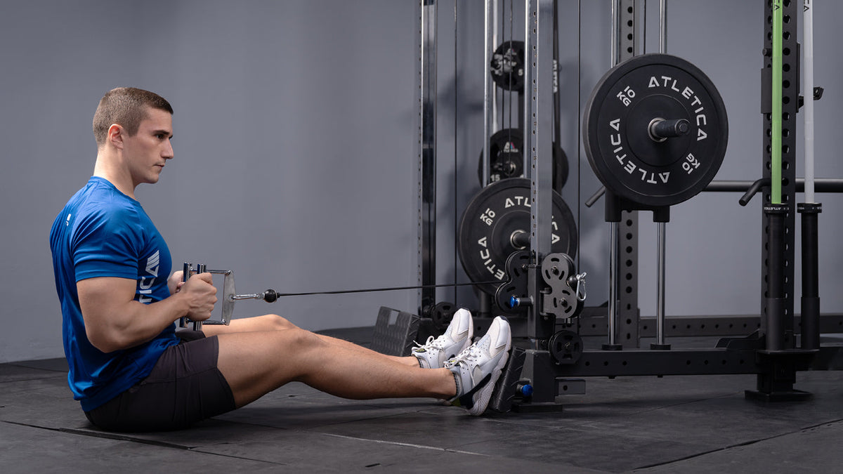 Man performing seated cable rows on the cable tower using a close V-handle for back training
