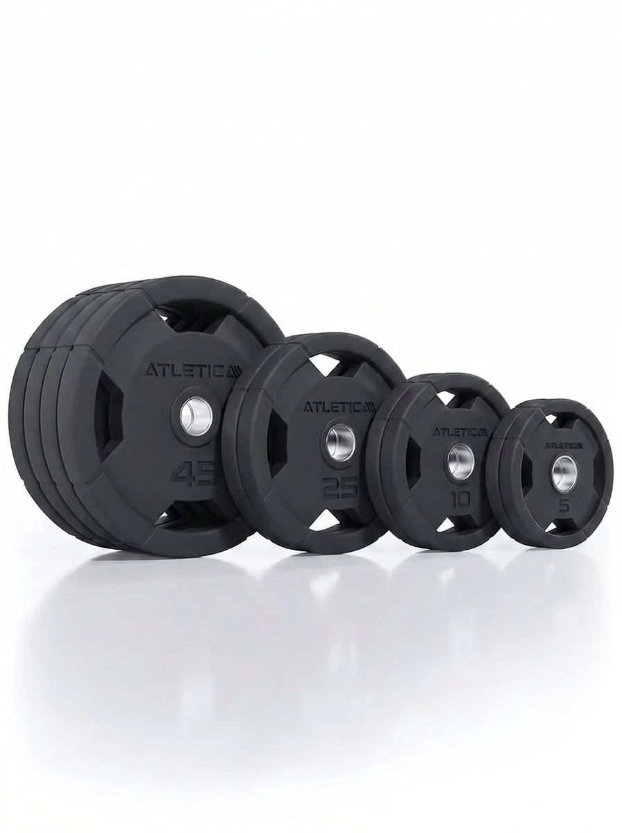 Atletica 4H rubber-coated gripper plates set 260 lb, angled view of stacked and standing plates