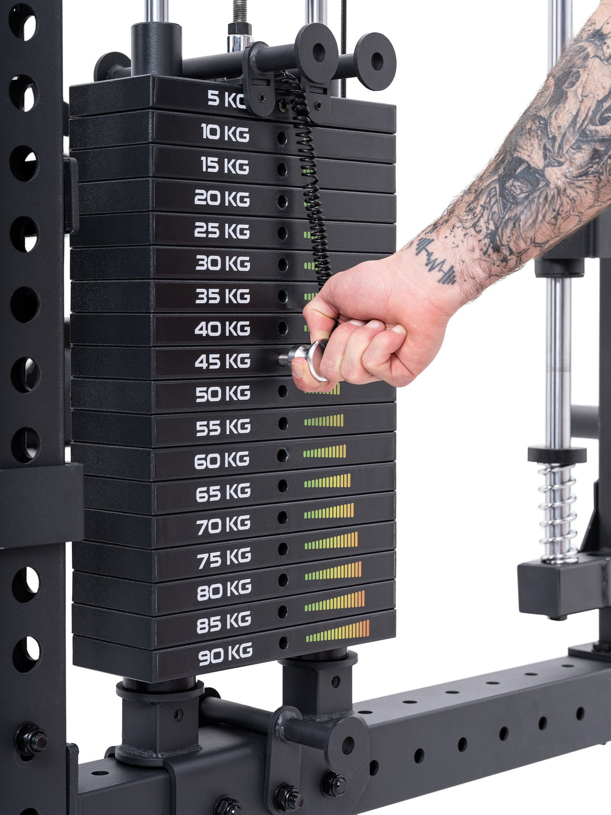Hand setting the pin in the weight stack of the Atletica R8 Bradley electric green rack, close-up