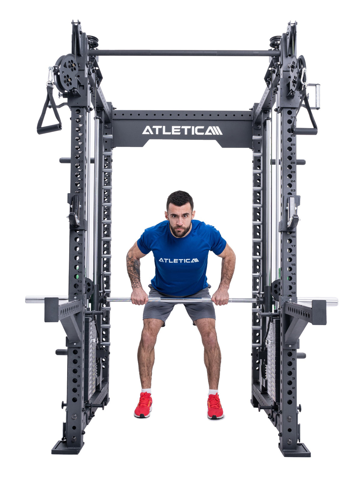 Man doing barbell deadlifts in the Atletica R8 Bradley Combat Long power rack