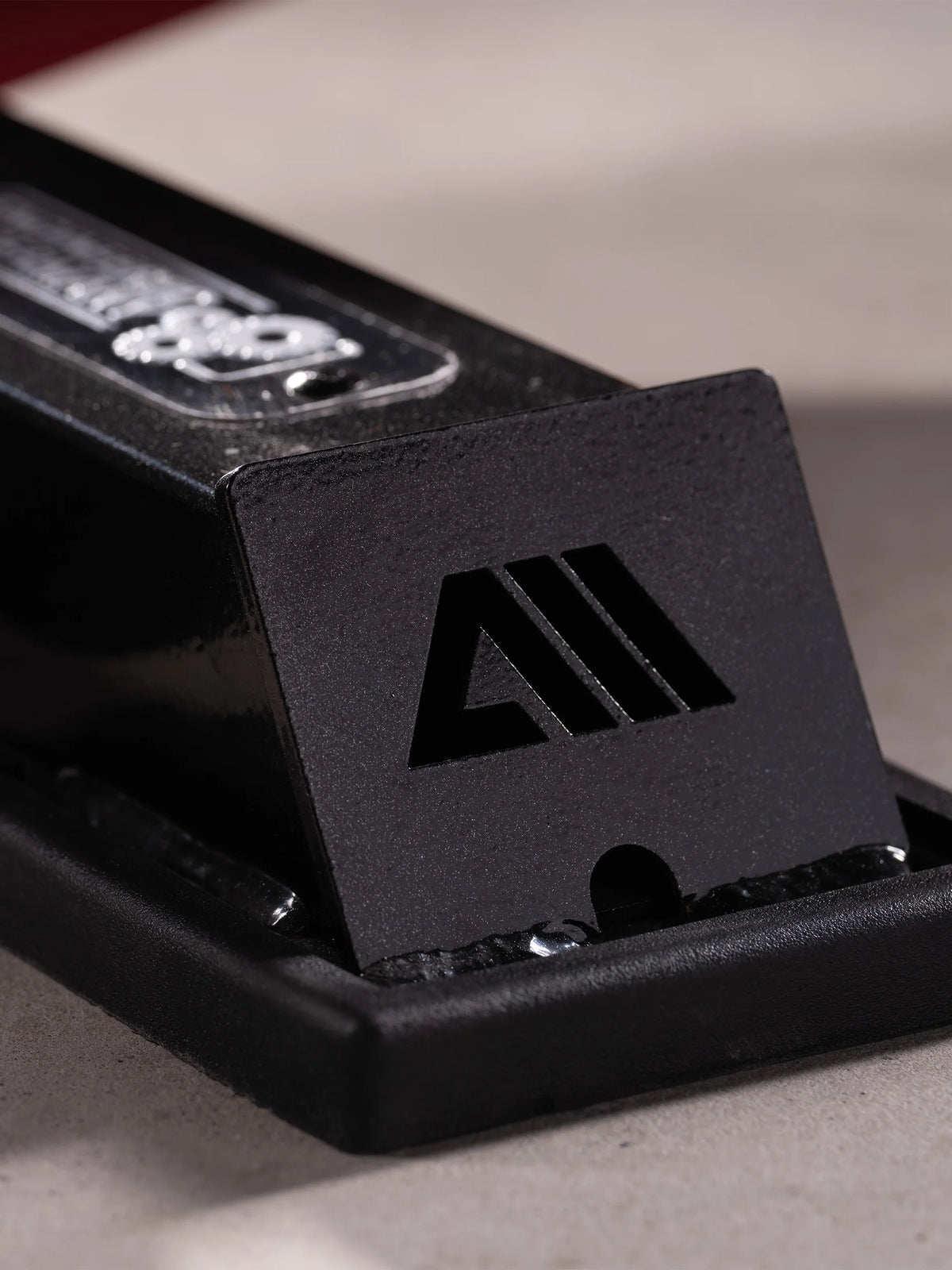 Atletica Raptor weight bench, detail of the rear foot with logo plate