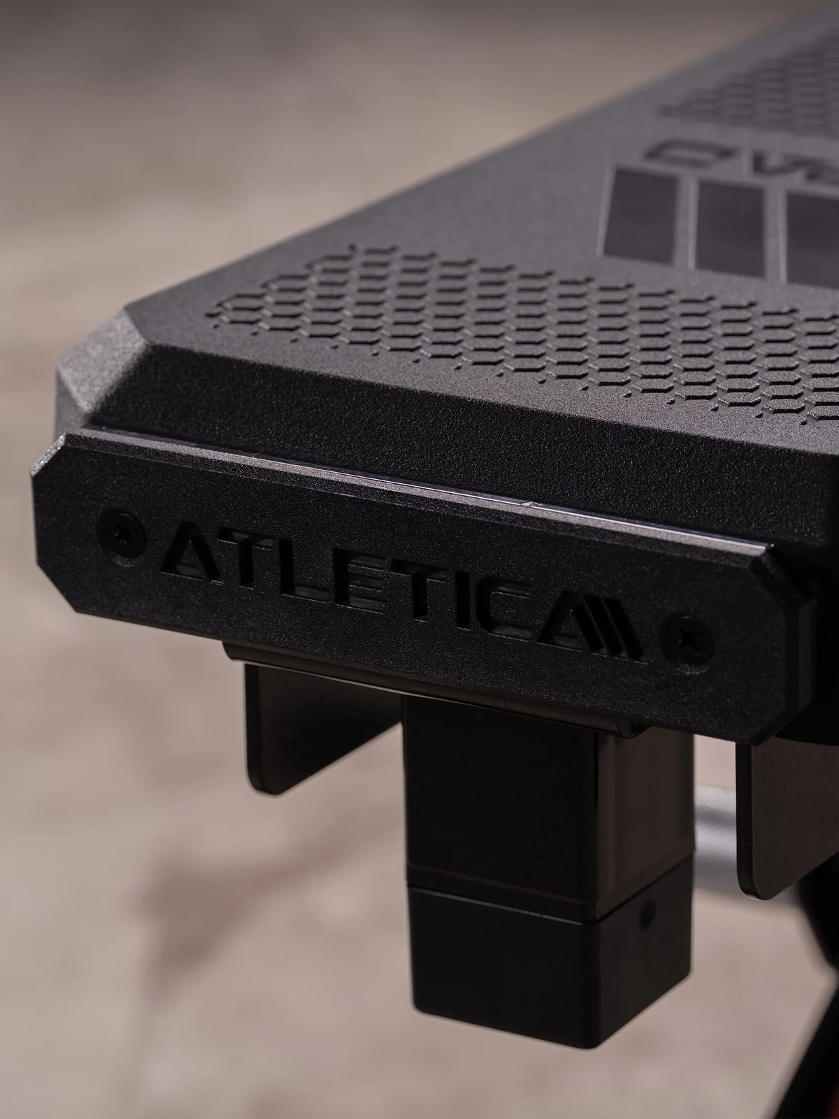 Atletica Raptor weight bench, close-up of the seat pad edge with embossed logo
