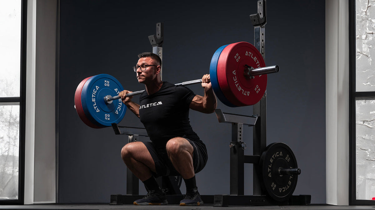 Back squat with barbell and Atletica Color Bumper Plates
