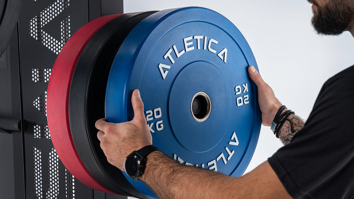 Athlete loading the Atletica Swat All-in-One Trainer with blue Color Bumper Plates, 45 lb