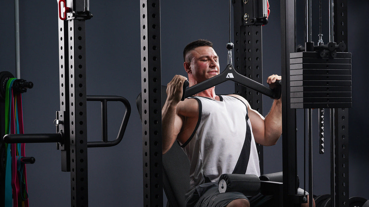 Man doing a lat pulldown on the Atletica Power Rack with Lat Pulldown station