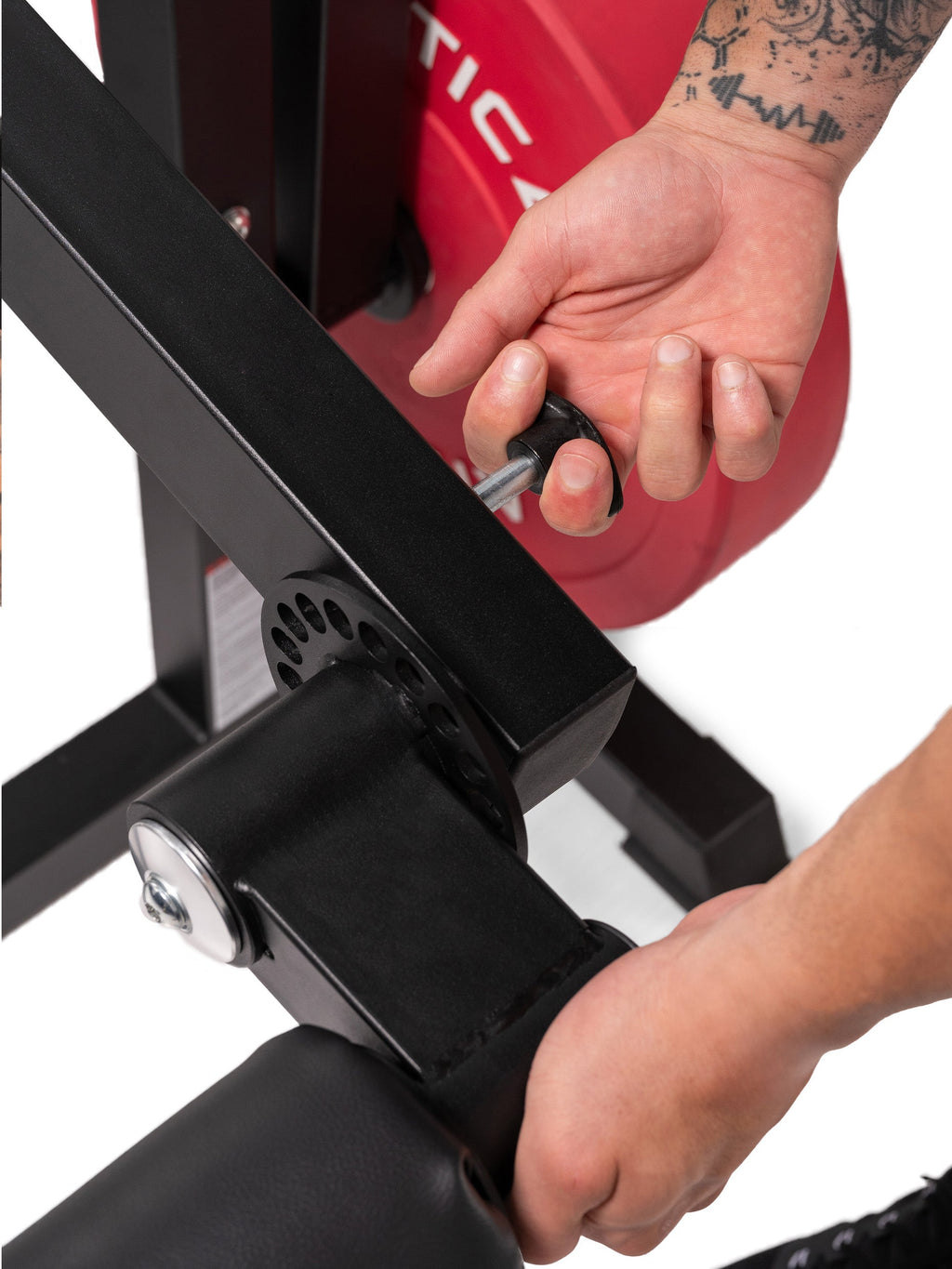 Leg & Core Multi-Trainer – adjusting the leg extension arm with the pop pin