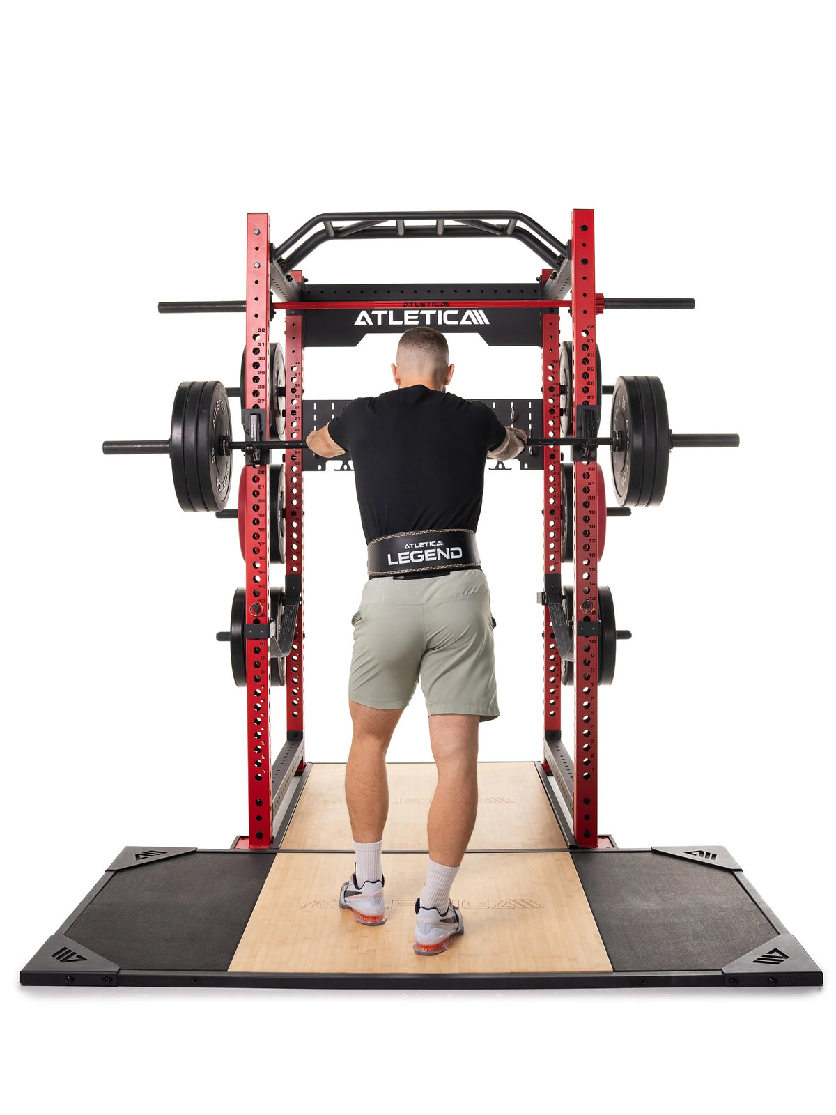 Man doing back squats on the Atletica deadlift platform, rear view