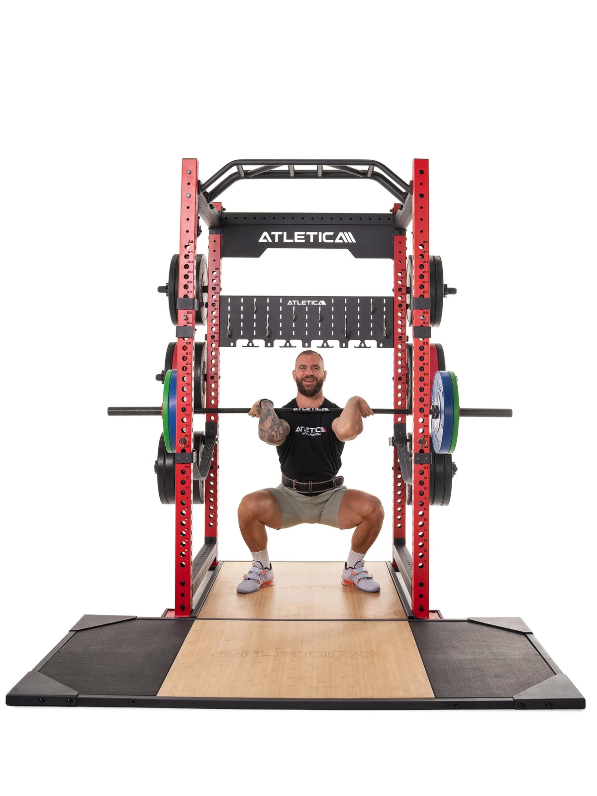 Deadlift Platform - man performs front squat in the power rack, barbell with weight plates