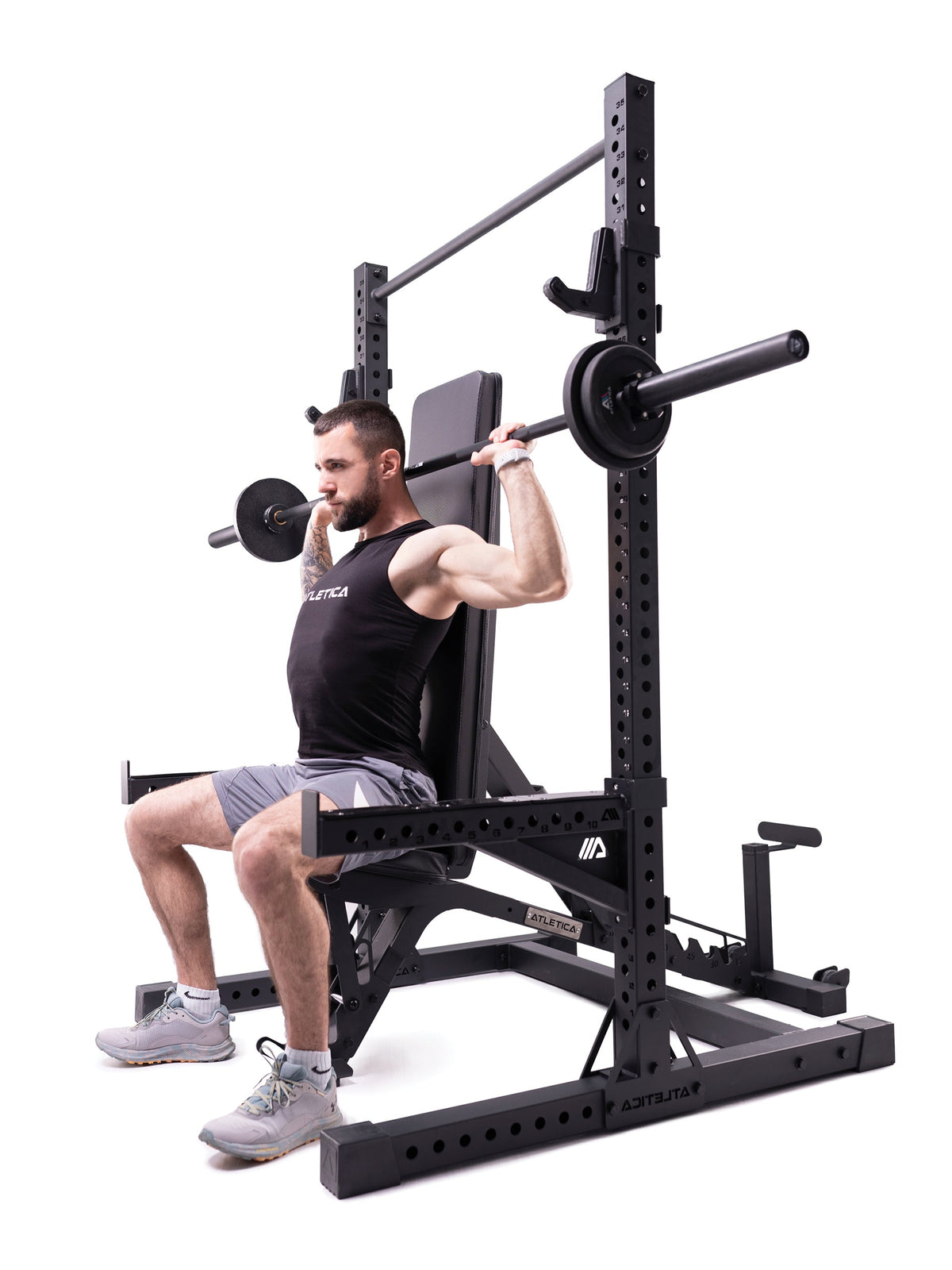 R7 Squat Rack with weight bench during shoulder press in 80" version – for squats, pull-ups and shoulder press