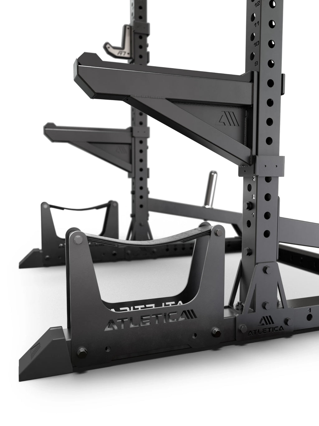ATLETICA R7 Half Rack – close-up of deadlift station, spotter arms and plate storage