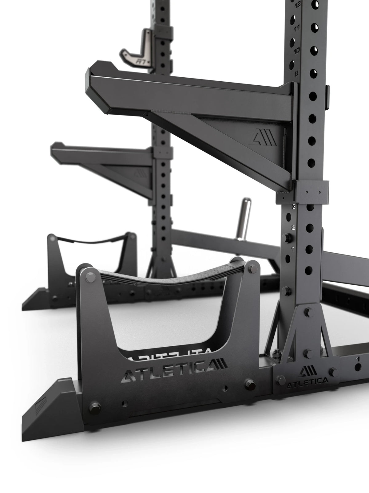 ATLETICA R7 Half Rack – close-up of deadlift station, spotter arms and plate storage