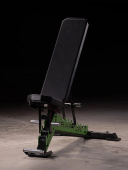 Atletica Raptor weight bench with Electric Green toothed plate and HexPad cushion in a dark studio