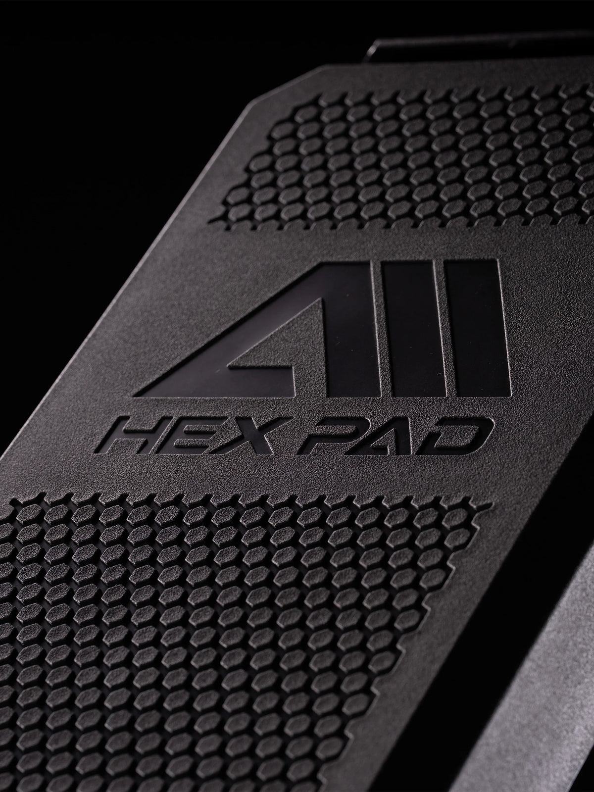 Atletica Raptor weight bench, close-up of the Hex Pad textured backrest surface with logo