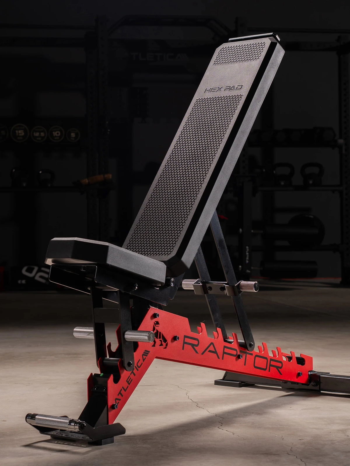 Atletica Raptor weight bench with HexPad and sports car red toothed frame, incline position, dark home gym