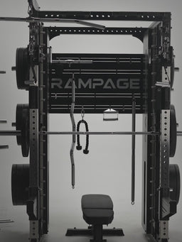 Man doing cable rows, pull-ups and loading plates on the Atletica Rampage all-in-one trainer