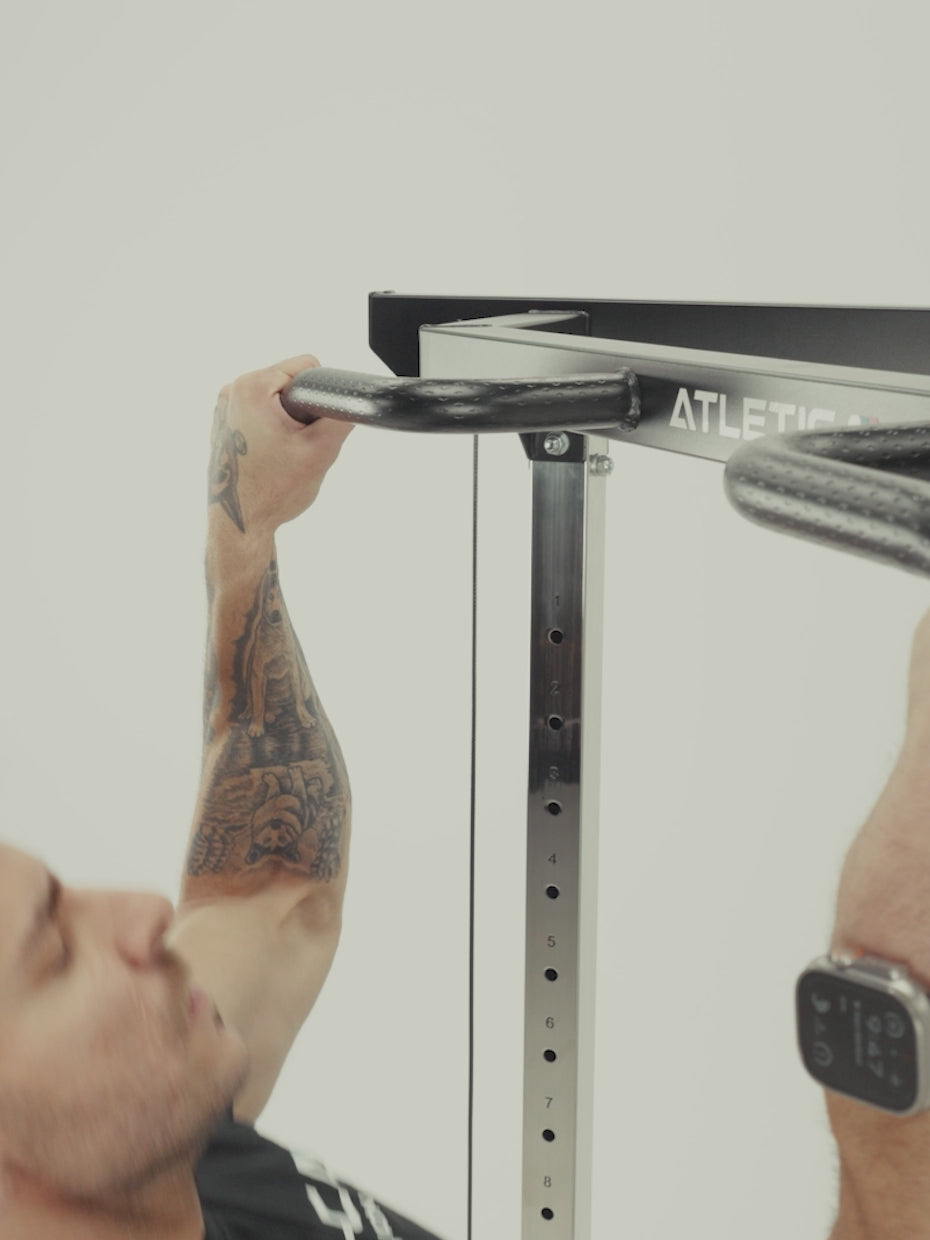 Man doing pull-ups and cable curls on the Atletica Harrier functional trainer, exercise chart detail
