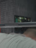 Video: Atletica Beta powerlifting bar in chrome, close-up of the knurled bar above a lifter