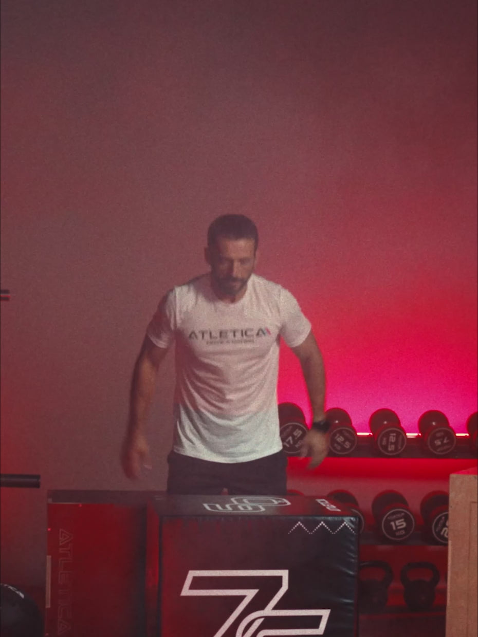 Video: man with the Atletica Plyobox SoftStep jump box in a gym with red lighting